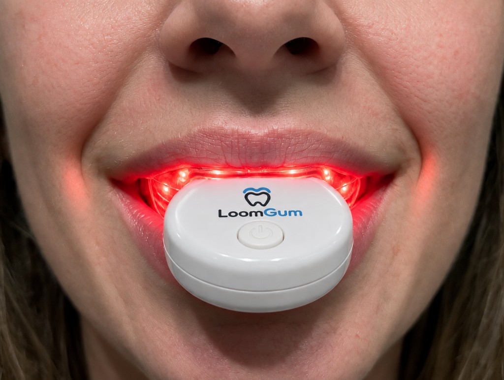 Red light glowing along the gumline